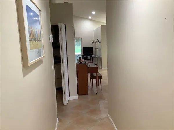 a view of kitchen with furniture and a refrigerator
