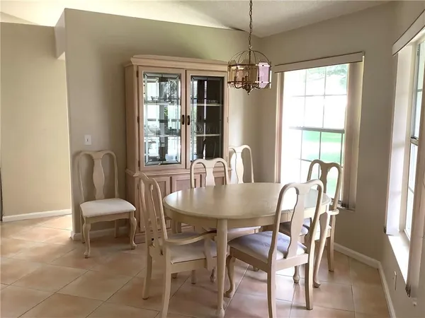 a view of a dining room with furniture window and outside view