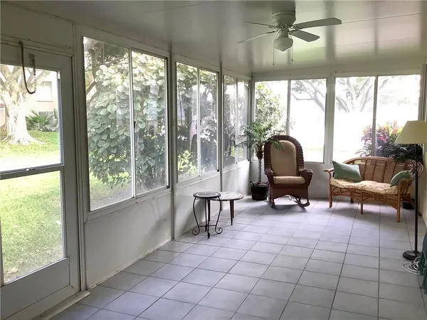 a living room with furniture and a floor to ceiling window