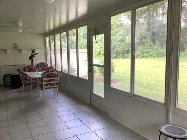 a room with furniture and large windows