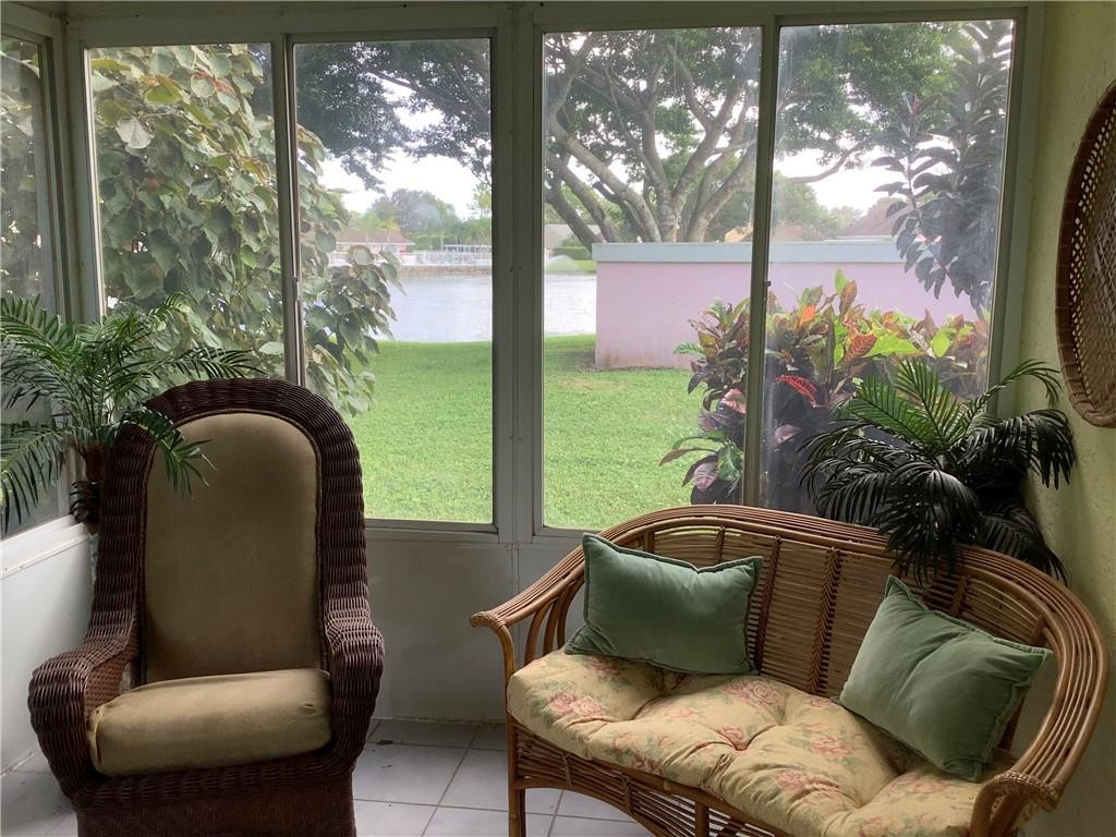 7904 Mansfield Hollow Road Delray Beach, FL 33446 - Photo 21 of 27 a living room with furniture and a potted plant