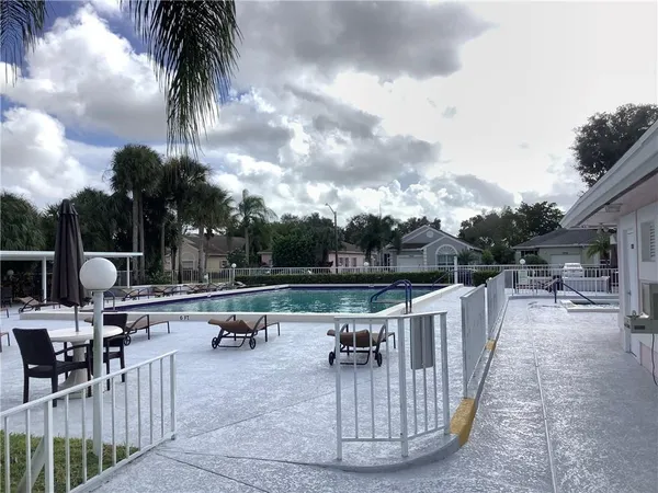a view of a swimming pool with a patio and a garden