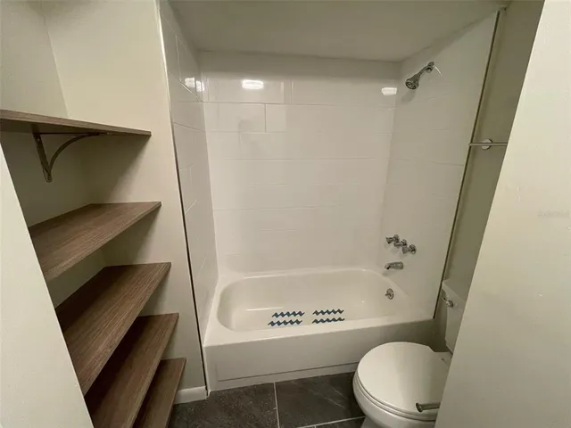 a bathroom with a toilet and a bathtub