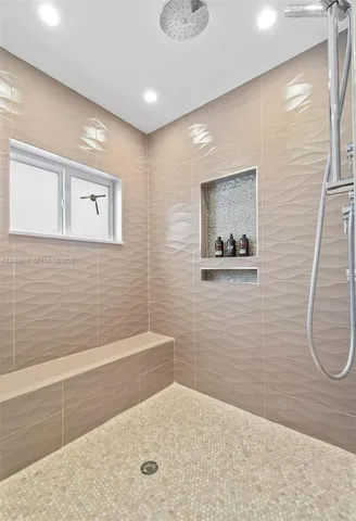 a bathroom with a white bath tub sitting next to a white sink