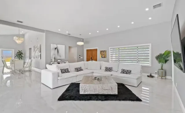 a dining room with furniture and a kitchen view