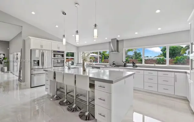 a kitchen with stainless steel appliances granite countertop a sink and cabinets