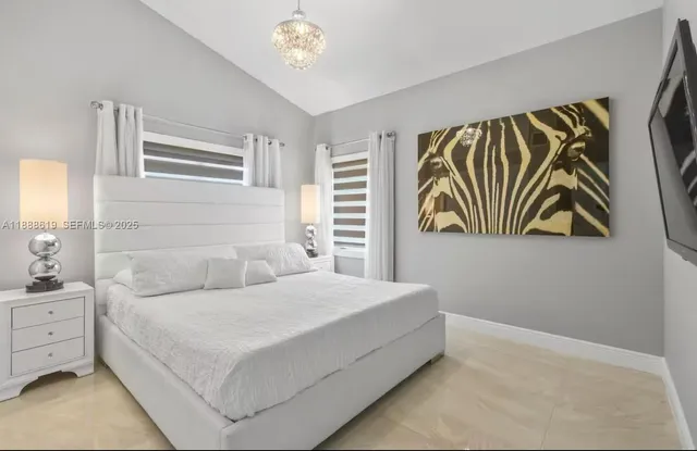 a bedroom with a bed and a night stand