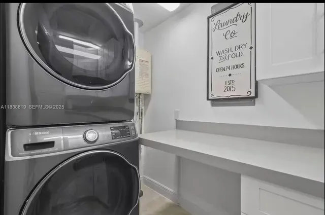a kitchen with white cabinets and a sink