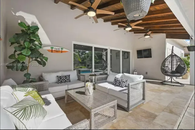 a view of a porch with couches and potted plants