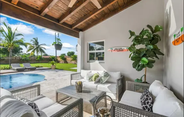 a view of a patio with table and chairs and potted plants