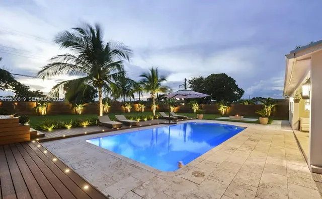 swimming pool view with a seating space