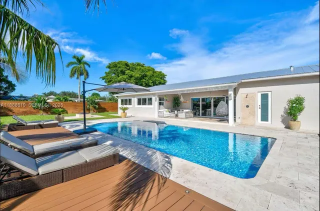 an aerial view of a residential houses with outdoor space