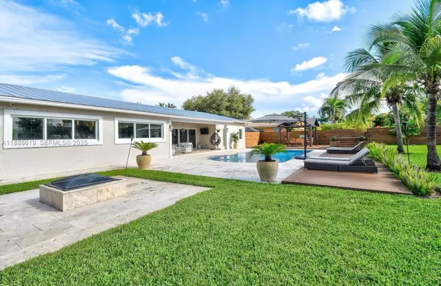 an aerial view of a house with a garden and trees