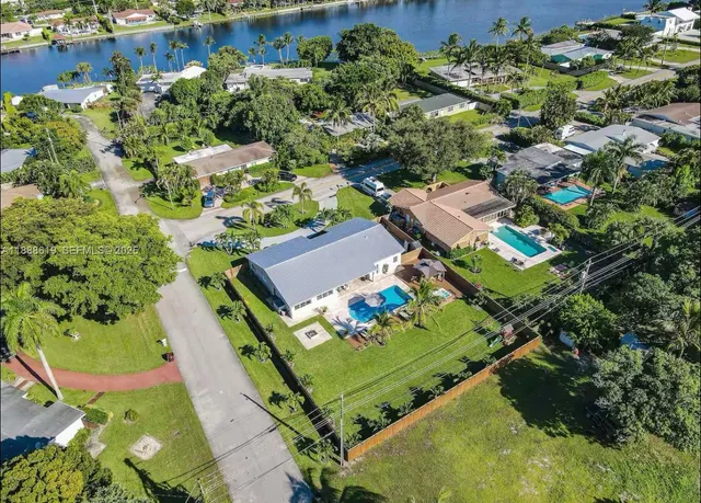 an aerial view of a house with a yard and outdoor seating
