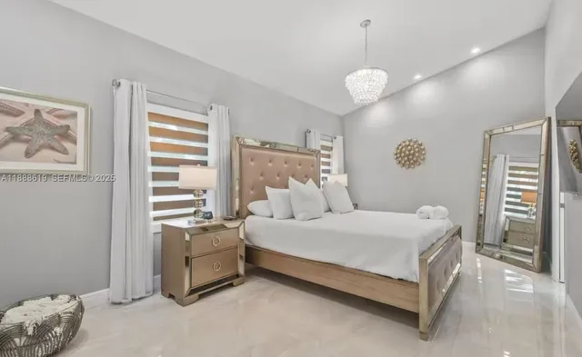 a bedroom with a bed and a television