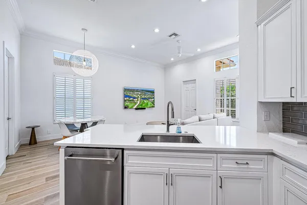 a kitchen with kitchen island granite countertop a sink stainless steel appliances and cabinets