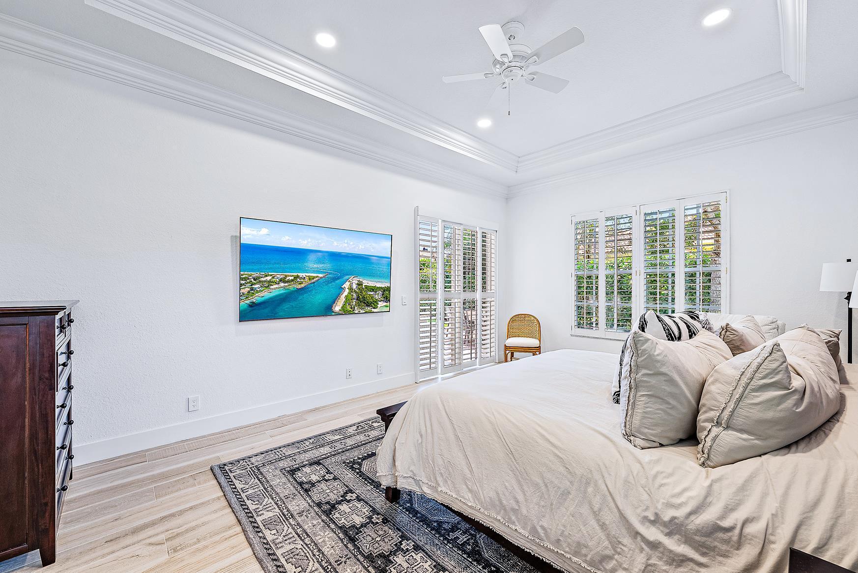 102 Via Santa Cruz Jupiter, FL 33458 - Photo 18 of 30 a bedroom with a large bed and a window