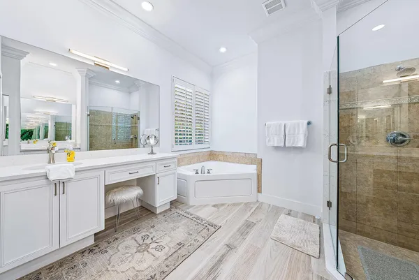 a bathroom with a tub sink and mirror
