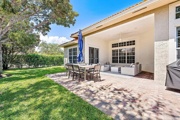 a view of a house with backyard and sitting area