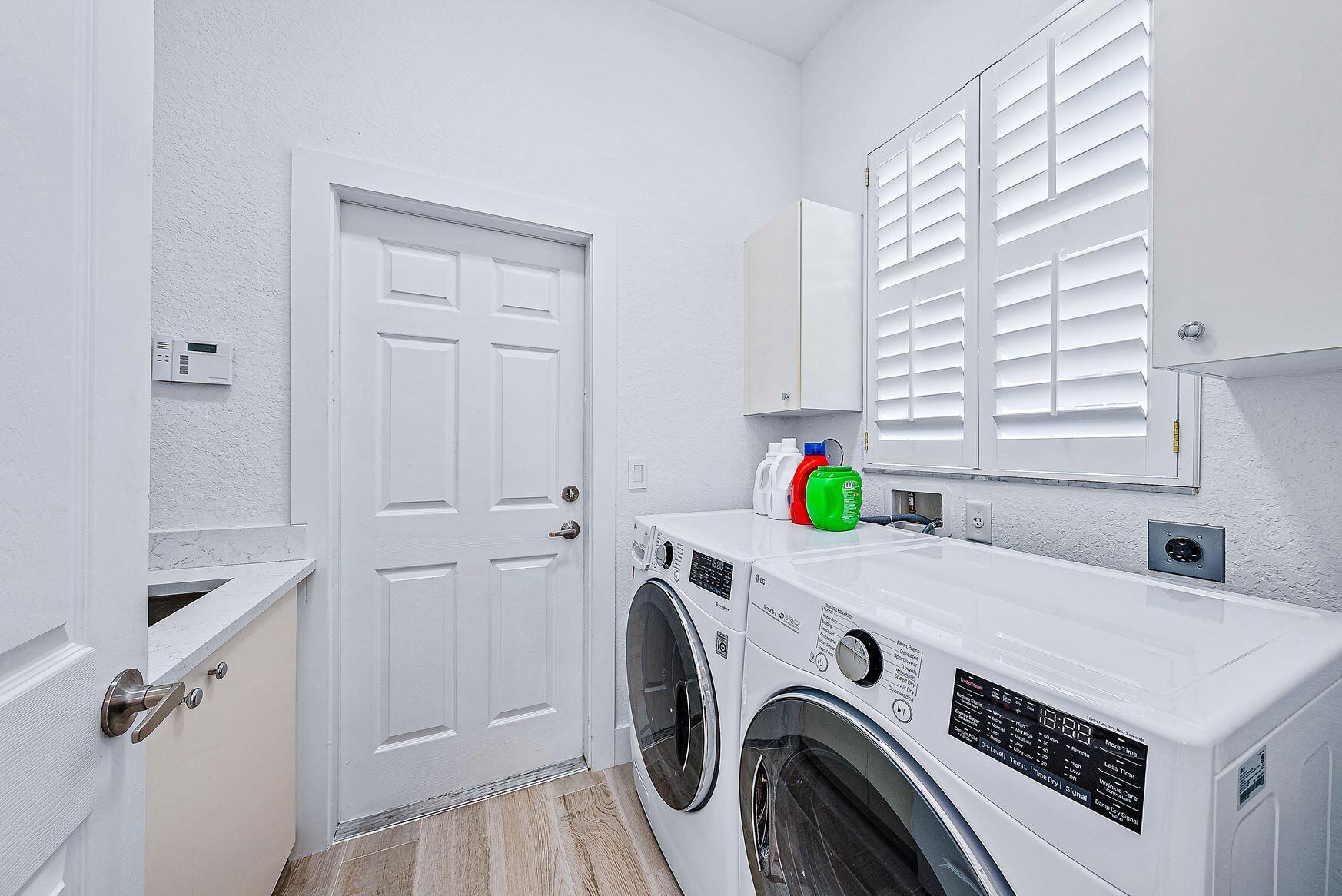 102 Via Santa Cruz Jupiter, FL 33458 - Photo 24 of 30 a utility room with dryer and washer