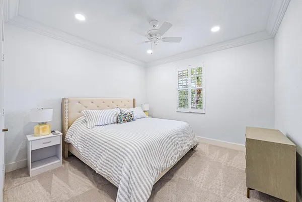 a bedroom with a large bed and a chandelier