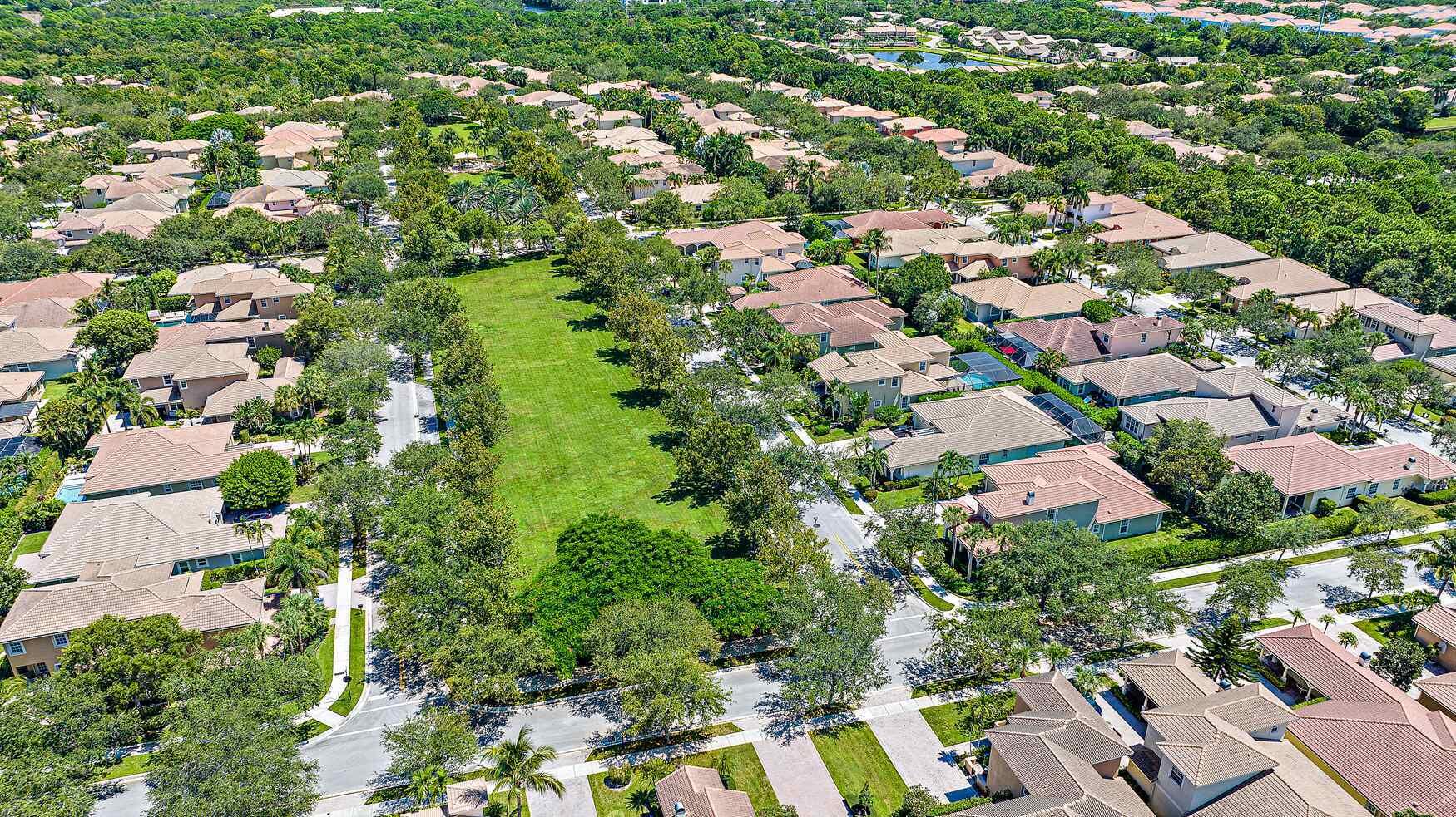 102 Via Santa Cruz Jupiter, FL 33458 - Photo 29 of 30 an aerial view of residential houses with outdoor space and trees