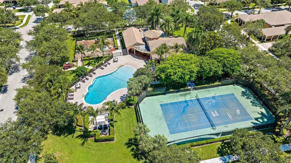 an aerial view of a house with a yard basket ball court and outdoor seating