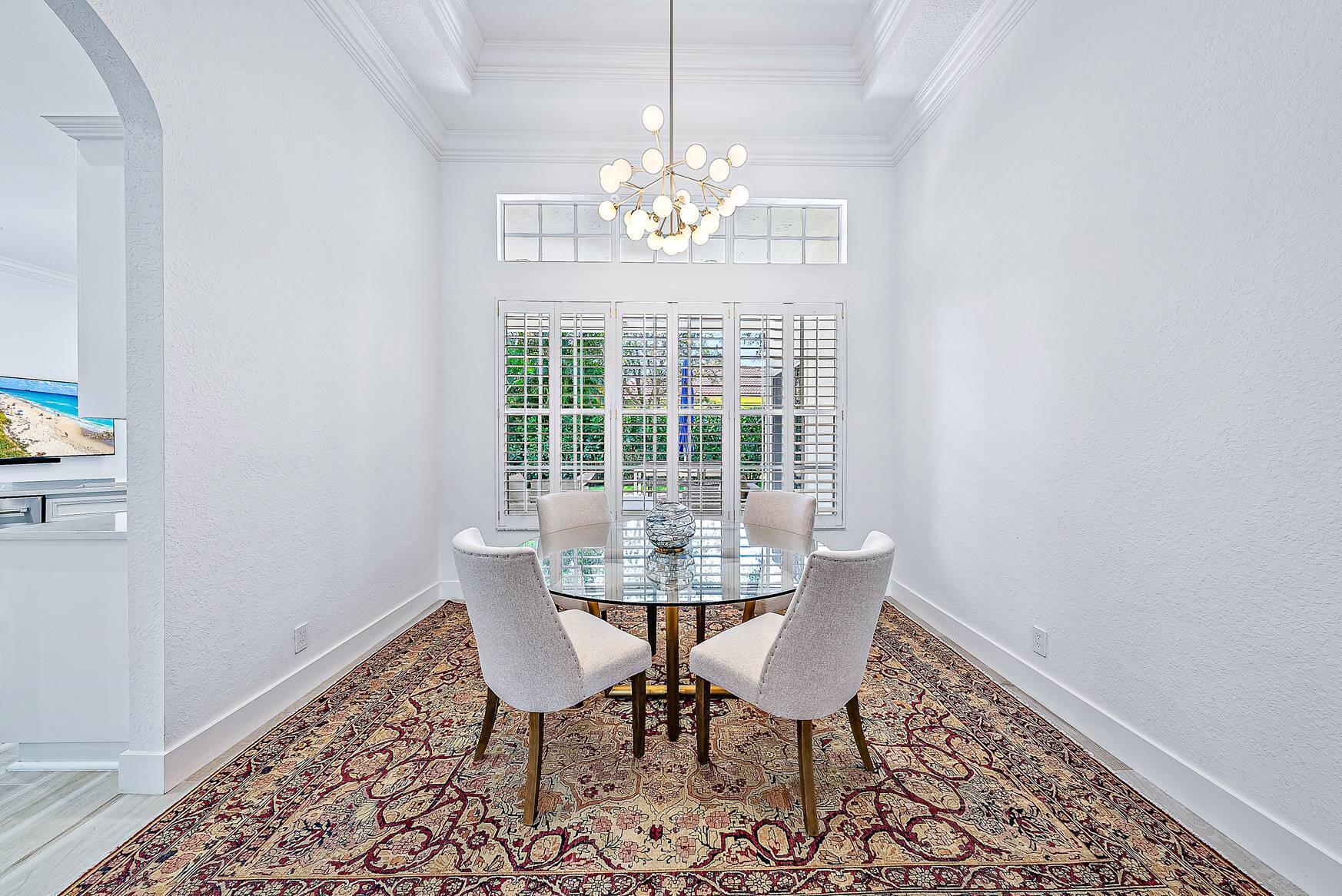 102 Via Santa Cruz Jupiter, FL 33458 - Photo 7 of 30 a view of a dining room with furniture and chandelier