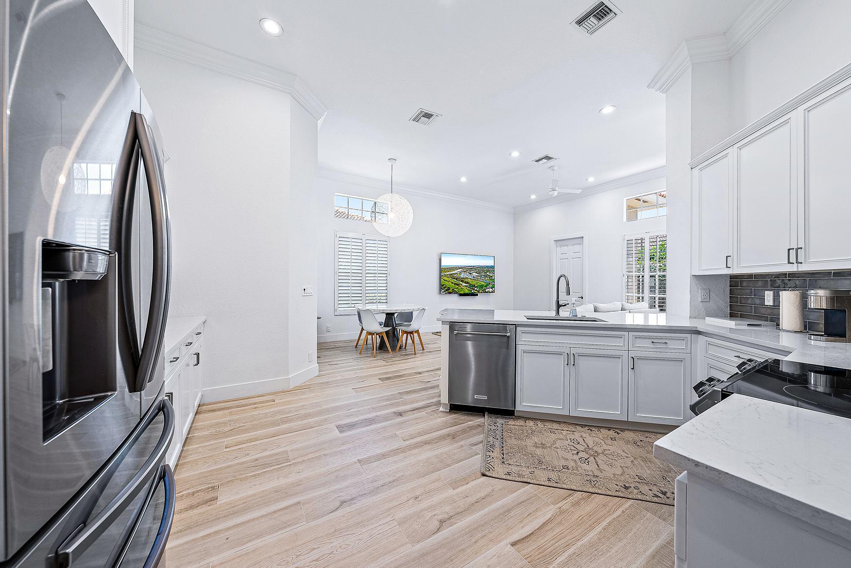 102 Via Santa Cruz Jupiter, FL 33458 - Photo 10 of 30 a kitchen with counter top space cabinets and stainless steel appliances