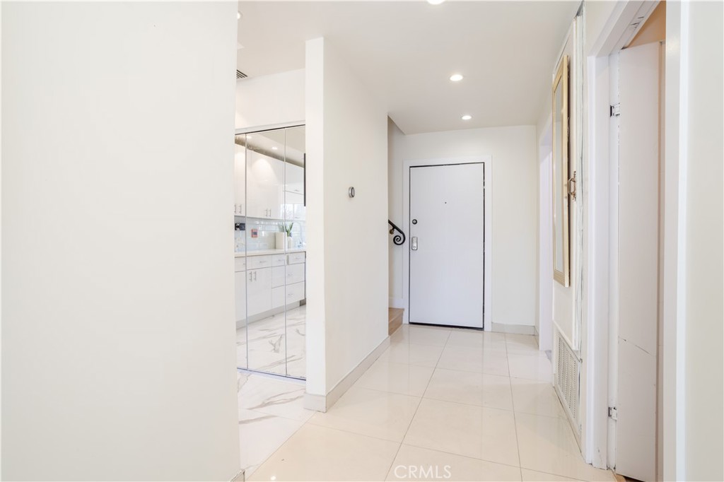 13331 Moorpark Street, Unit 319 Sherman Oaks, CA 91423 - Photo 12 of 46 a view of a hallway with wooden floor and a bathroom