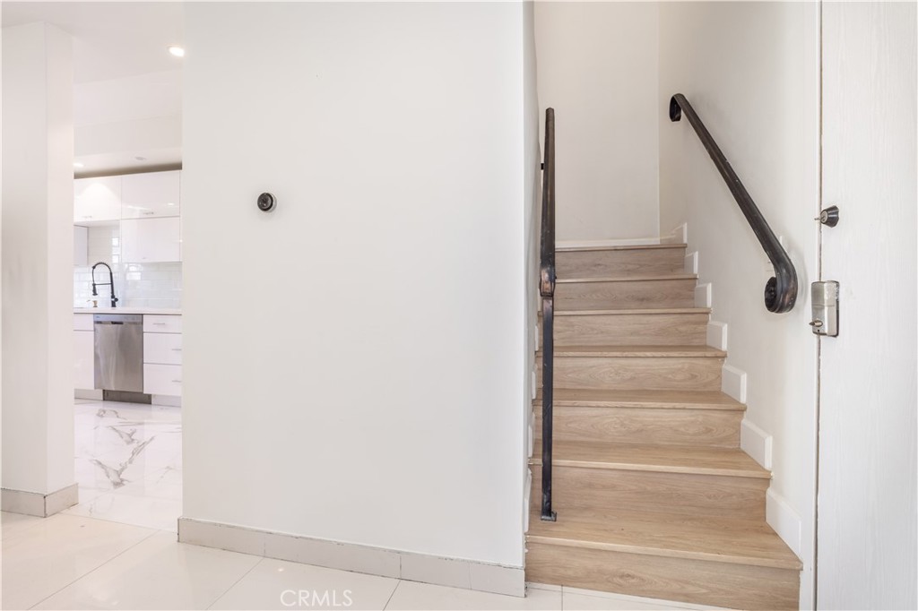 13331 Moorpark Street, Unit 319 Sherman Oaks, CA 91423 - Photo 14 of 46 a view of staircase with white walls and railing