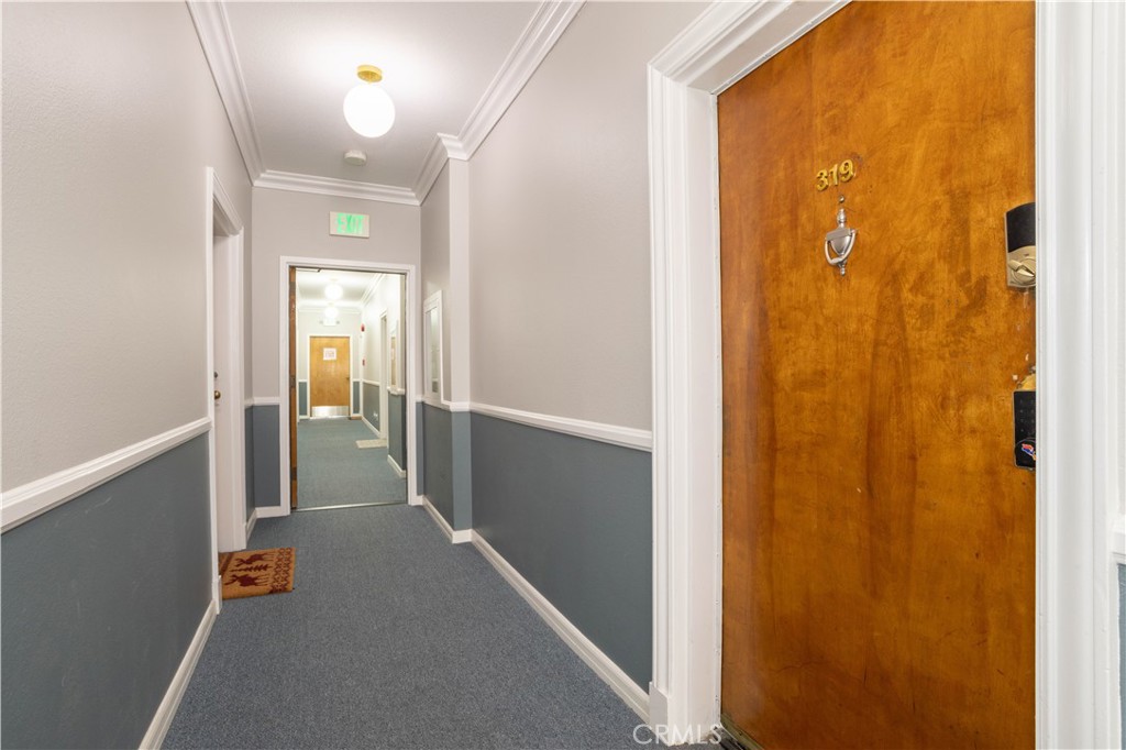 13331 Moorpark Street, Unit 319 Sherman Oaks, CA 91423 - Photo 22 of 46 a view of a hallway with wooden shelves