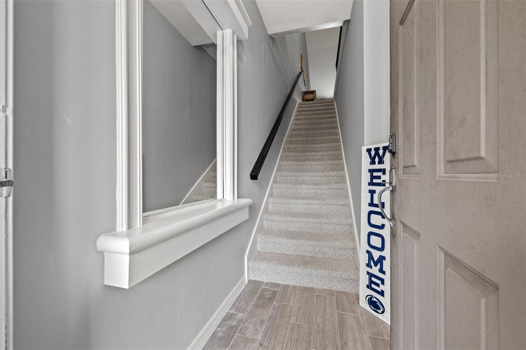 1039 Normandy Trace Road, Unit 1039 Tampa, FL 33602 - Photo 3 of 19 a view of staircase with white walls and windows