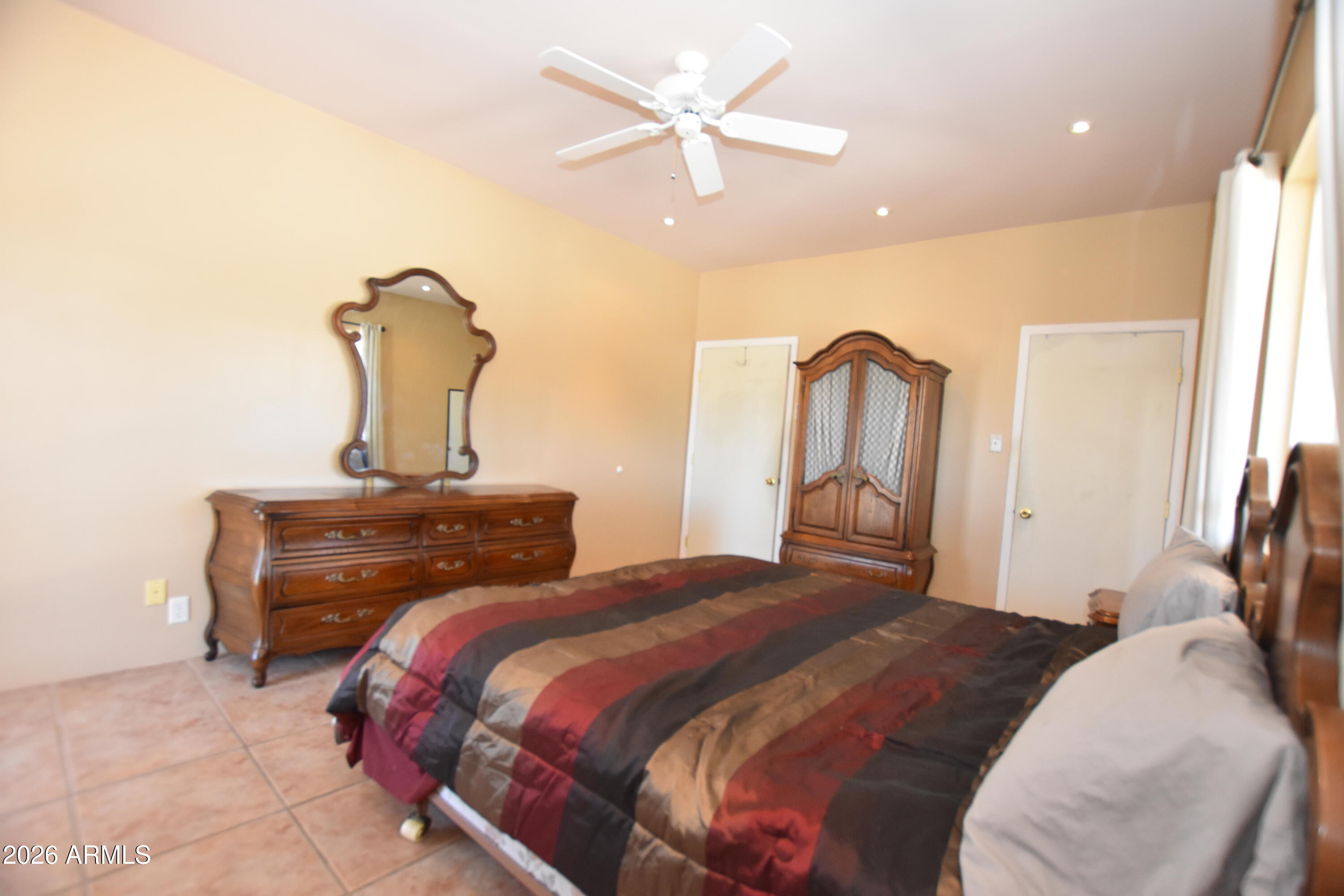 1140 West Briggs Road Ajo, AZ 85321 - Photo 13 of 42 a bedroom with a bed and a chandelier