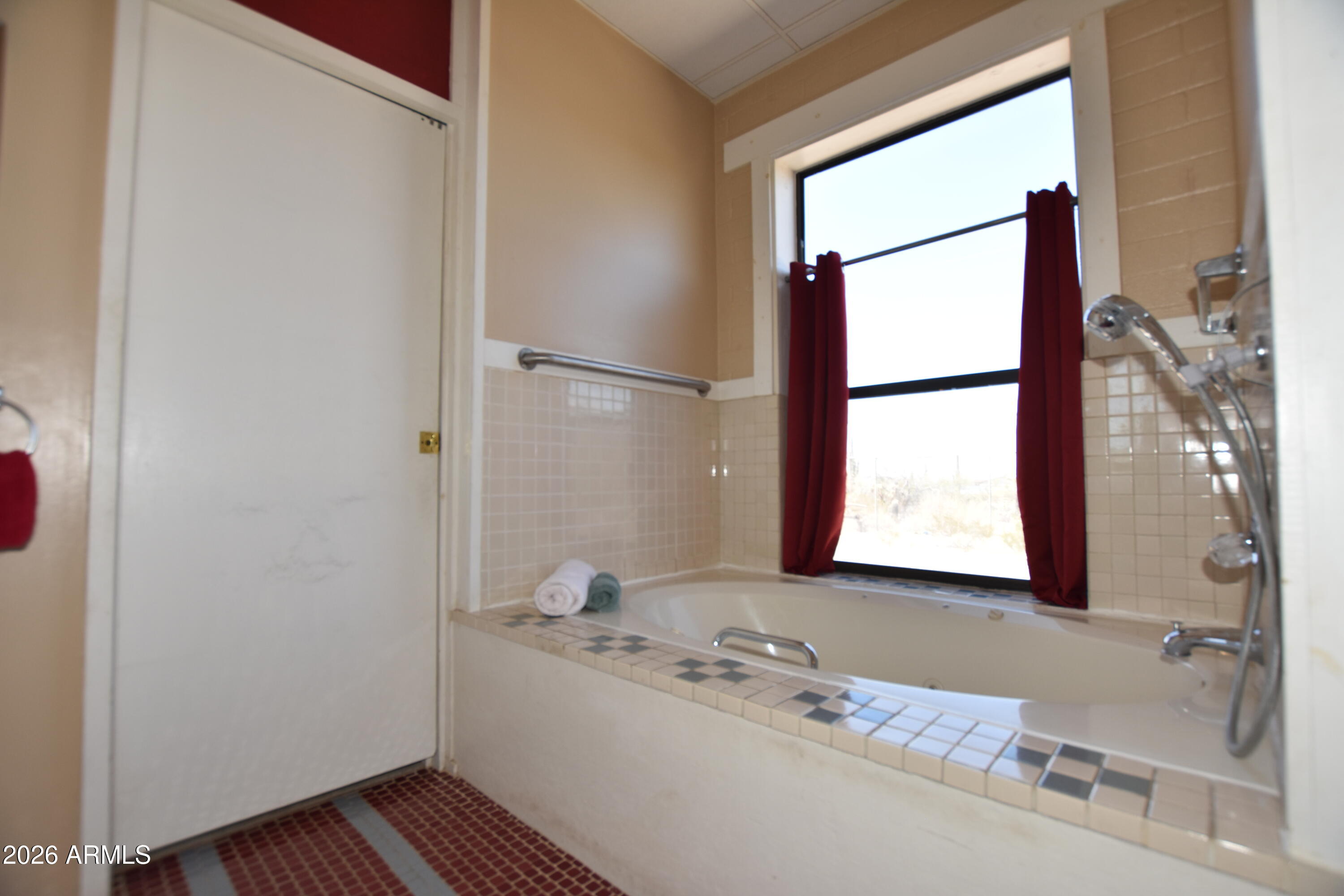 1140 West Briggs Road Ajo, AZ 85321 - Photo 17 of 42 a bathroom with a granite countertop sink and a mirror