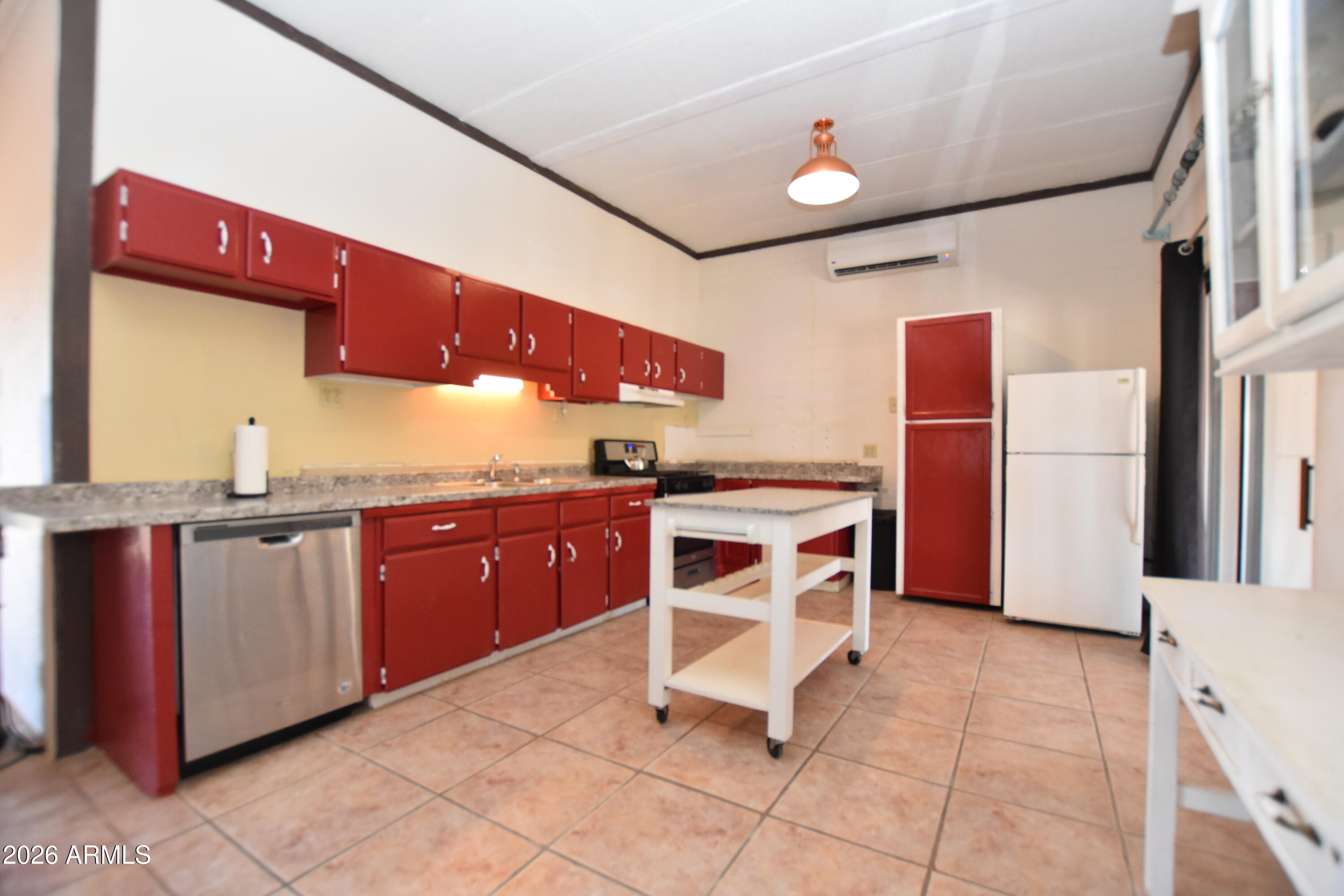 1140 West Briggs Road Ajo, AZ 85321 - Photo 2 of 42 a kitchen with stainless steel appliances granite countertop a stove a sink and a microwave
