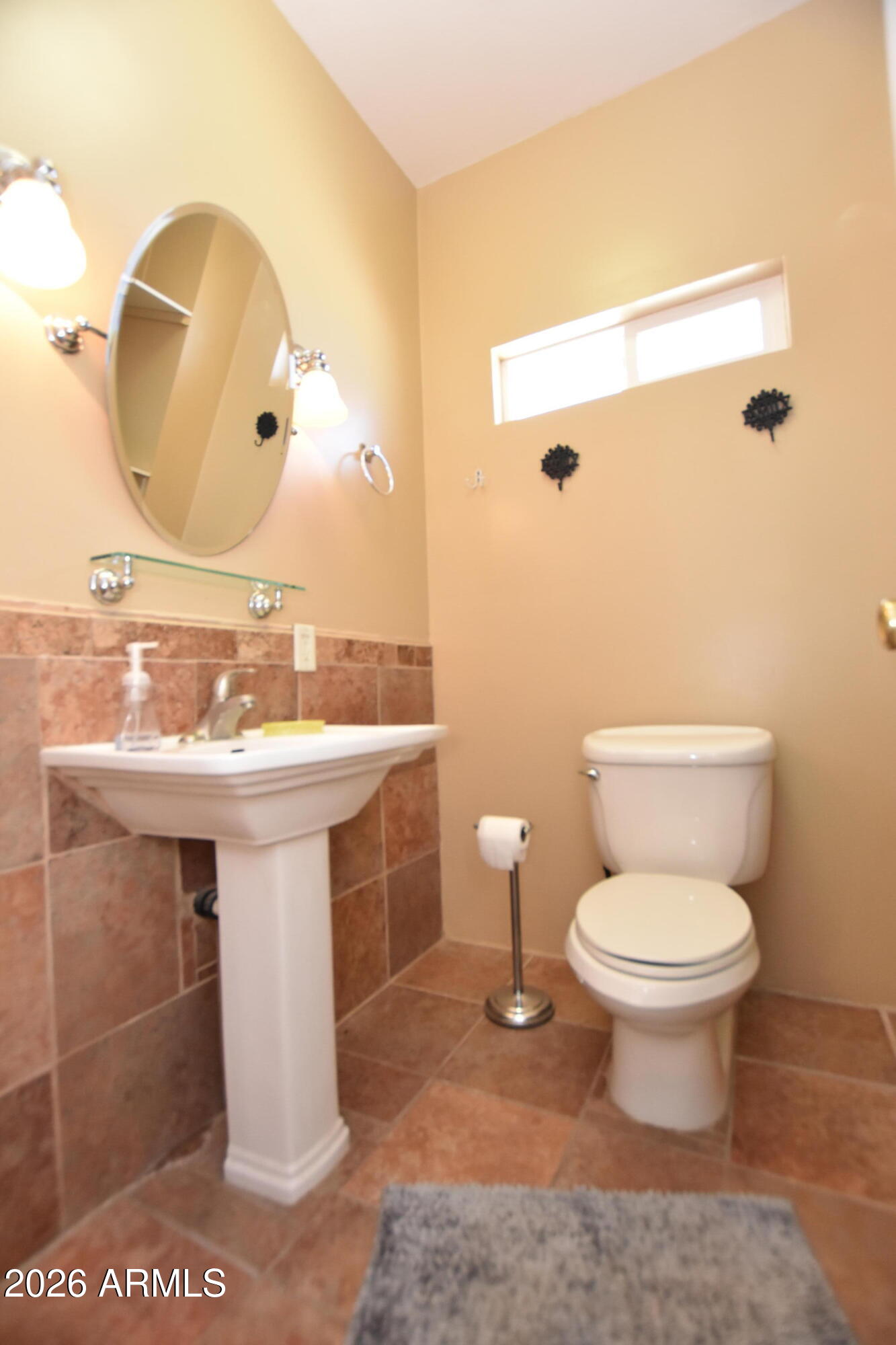 1140 West Briggs Road Ajo, AZ 85321 - Photo 21 of 42 a bathroom with a sink toilet and mirror