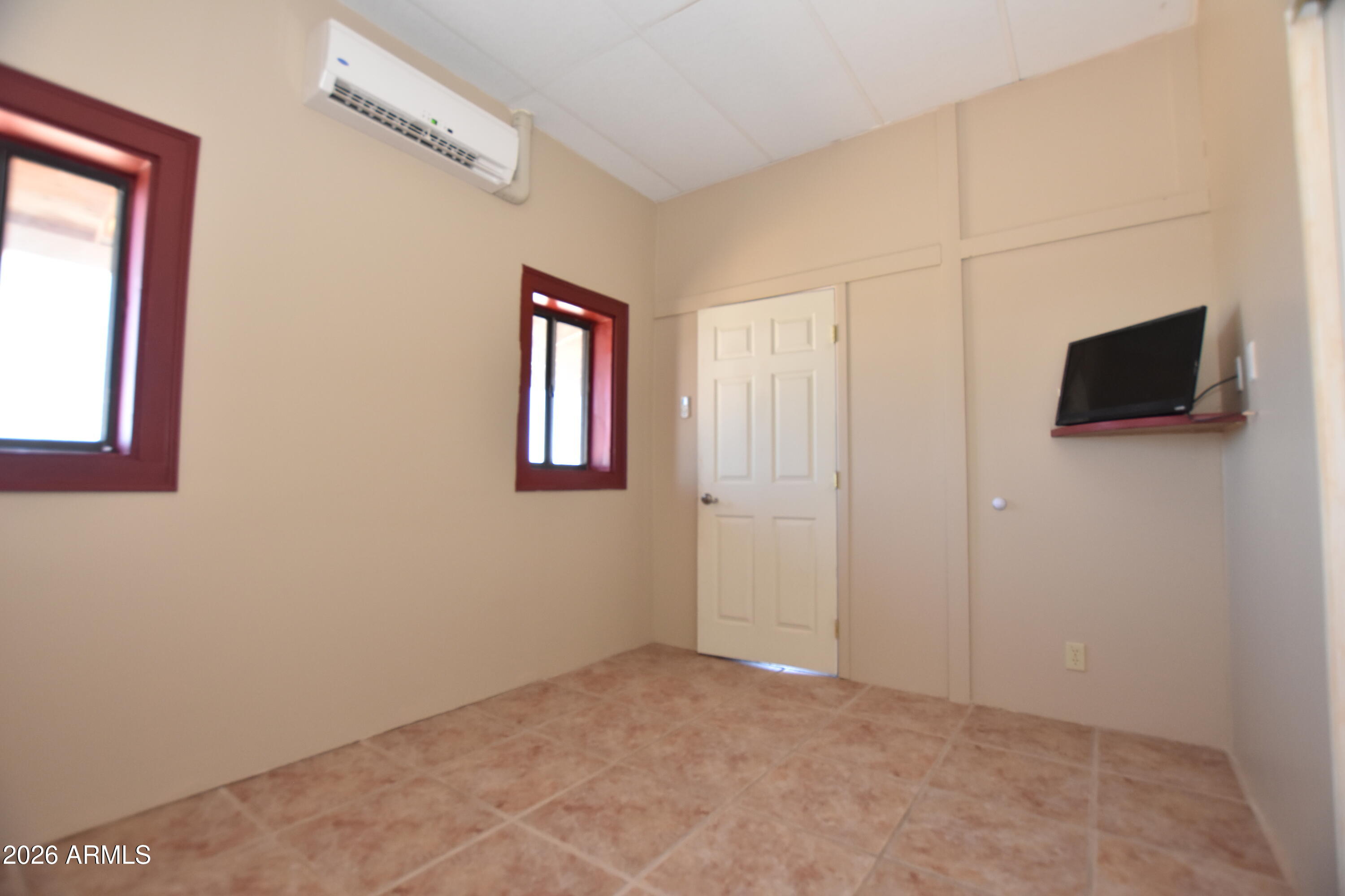 1140 West Briggs Road Ajo, AZ 85321 - Photo 23 of 42 a view of an empty room with a tv