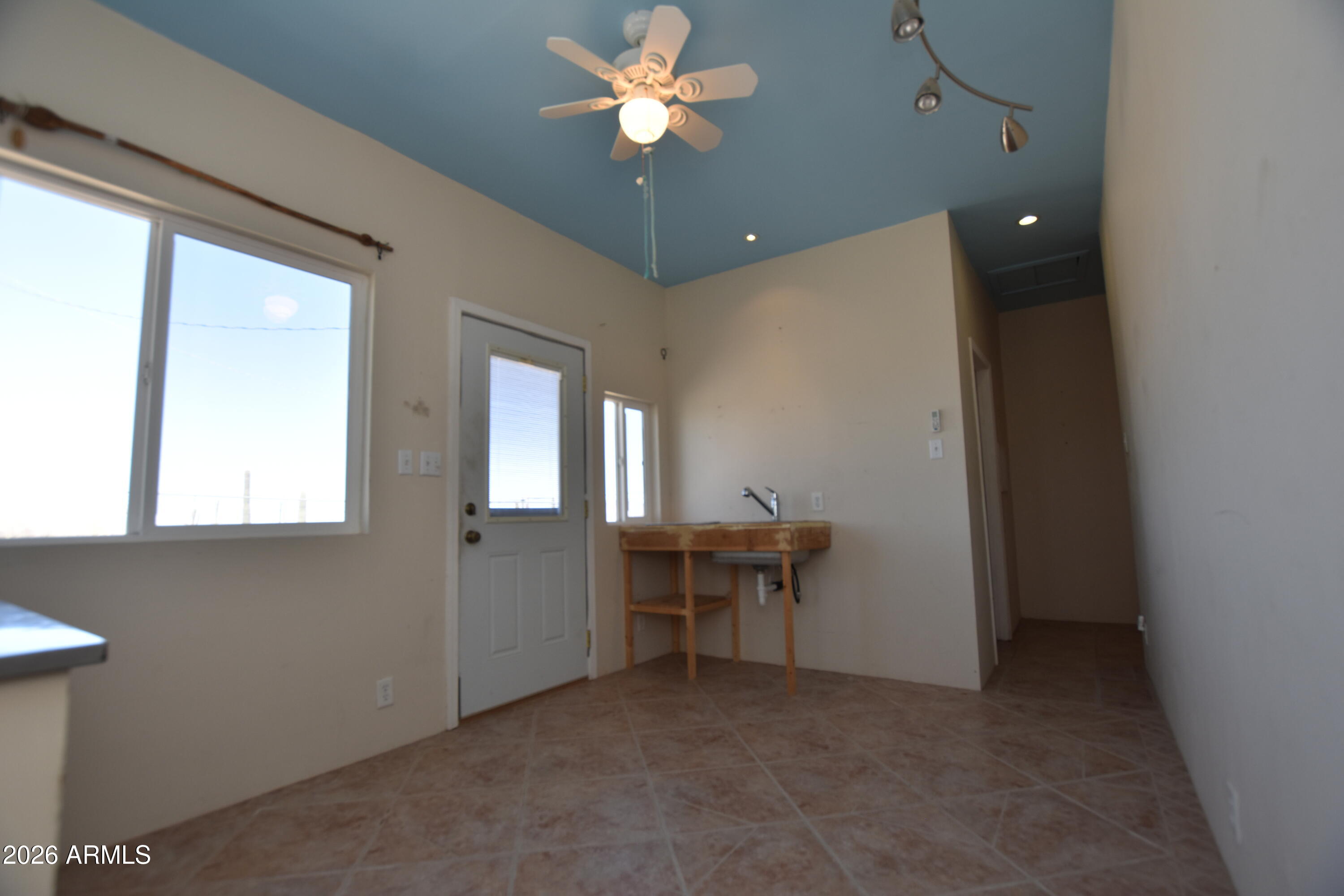 1140 West Briggs Road Ajo, AZ 85321 - Photo 41 of 42 a view of workspace with a window and a chandelier fan