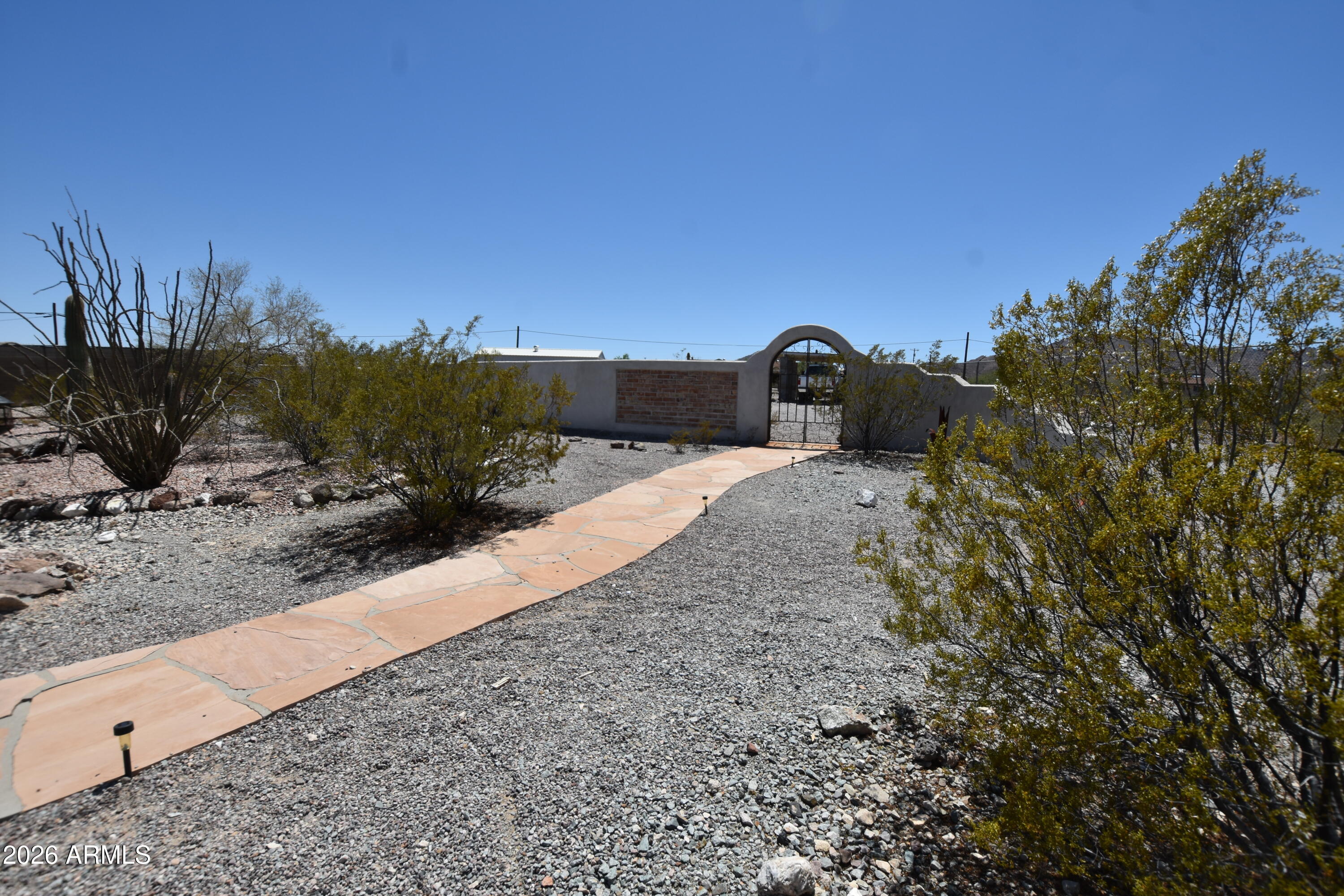 1140 West Briggs Road Ajo, AZ 85321 - Photo 8 of 42 a view of a dry yard with trees