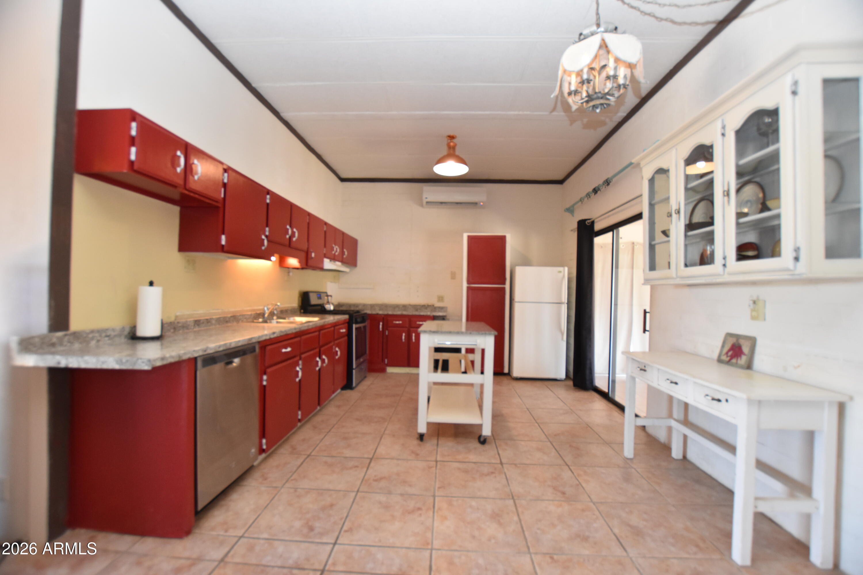 1140 West Briggs Road Ajo, AZ 85321 - Photo 9 of 42 a large kitchen with stainless steel appliances granite countertop a sink and cabinets