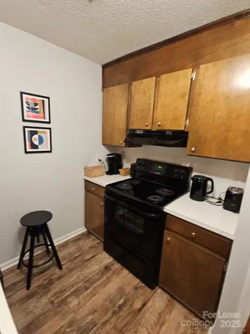 a kitchen with a stove and a refrigerator