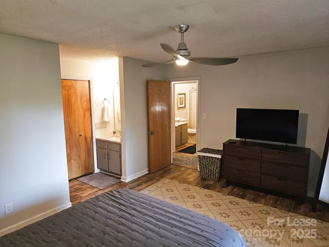 a bedroom with furniture and a flat screen tv