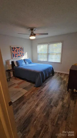 a bed sitting in a bedroom next to a window