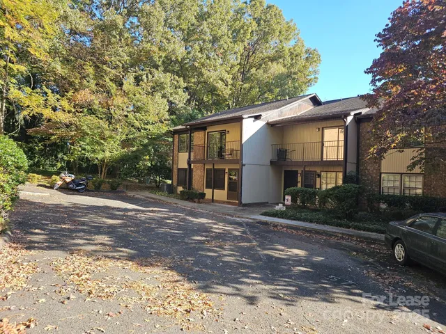 a view of a house with a yard and street
