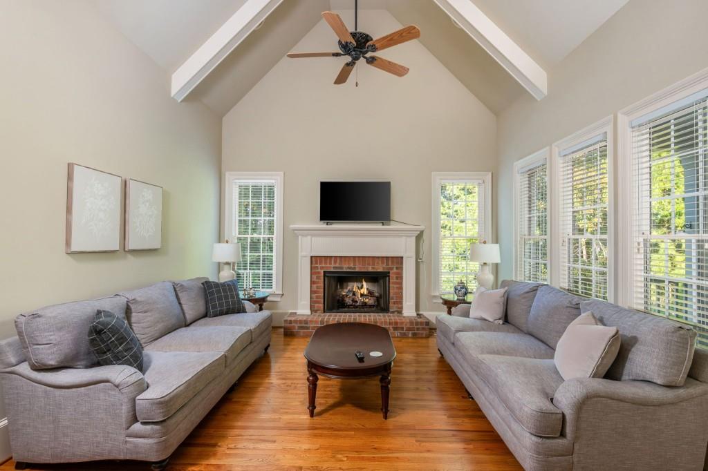 220 Edwards Brook Court Canton, GA 30115 - Photo 33 of 77 a living room with furniture a fireplace and a large window