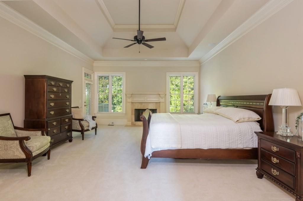 220 Edwards Brook Court Canton, GA 30115 - Photo 36 of 77 a bedroom with a bed and a couch