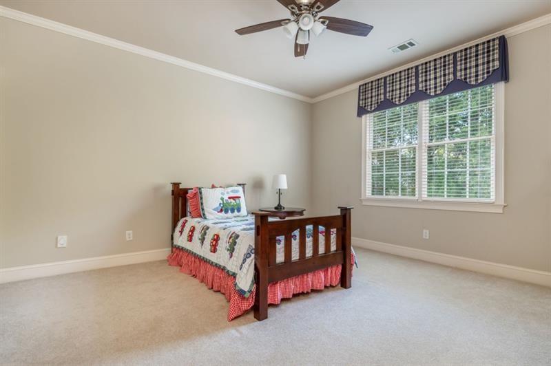 220 Edwards Brook Court Canton, GA 30115 - Photo 52 of 77 a bedroom with a bed and window