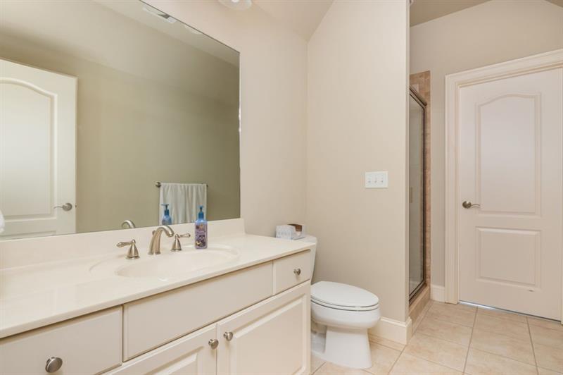 220 Edwards Brook Court Canton, GA 30115 - Photo 53 of 77 a bathroom with a sink a toilet and a mirror
