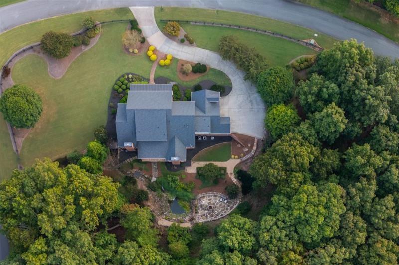 220 Edwards Brook Court Canton, GA 30115 - Photo 72 of 77 an aerial view of a house with outdoor space and a lake view